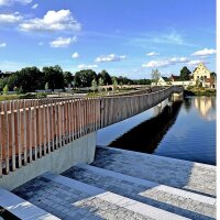 Über den wieder errichteten historischen Stadtteich führt eine neue attraktive Brücke mit vertikalem Holzgeländer
