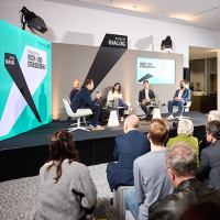 Blick auf ein Podium mit fünf diskutierenden Personen